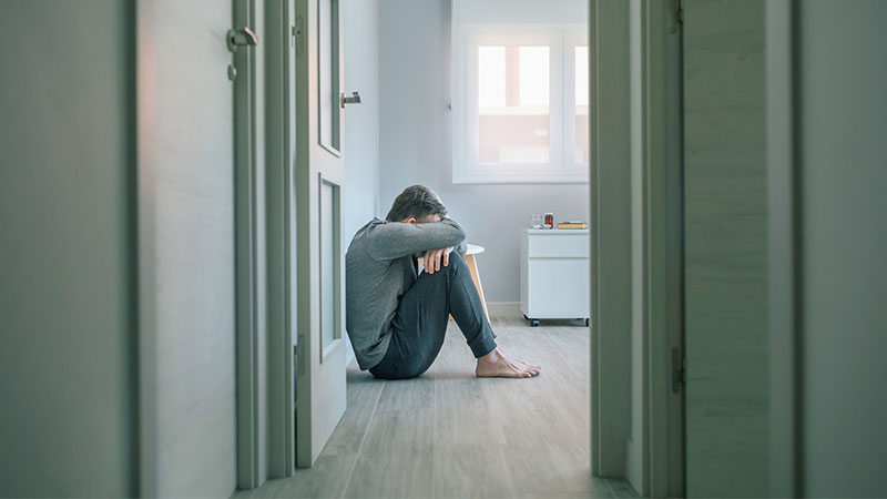 man mental disorder crying sitting room floor