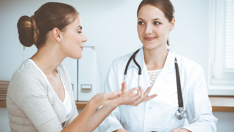Doctor and patient are sitting and discussing health examination