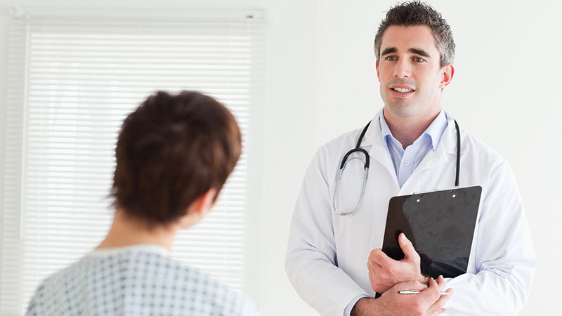 male physician discusses health matters with a woman