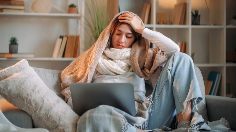 feeling unwell sitting sofa in living room