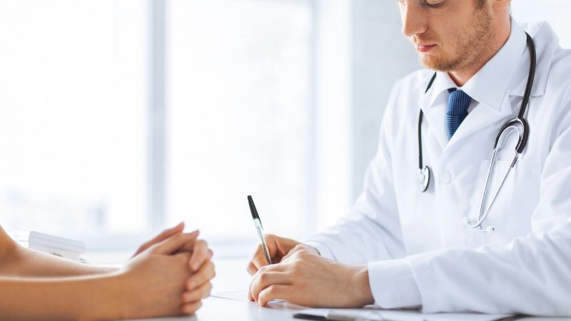 Patient and doctor taking notes