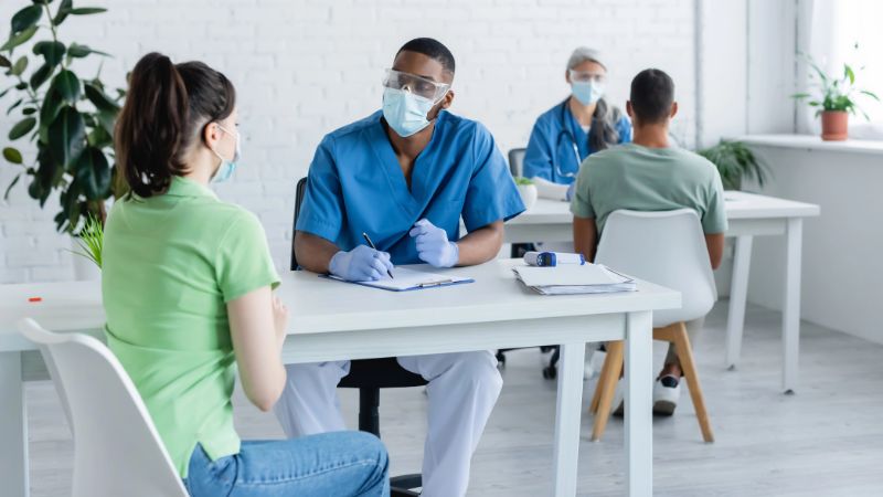 doctors in medical masks talking to patients