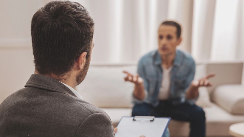 Psychologist listening to his anxious client