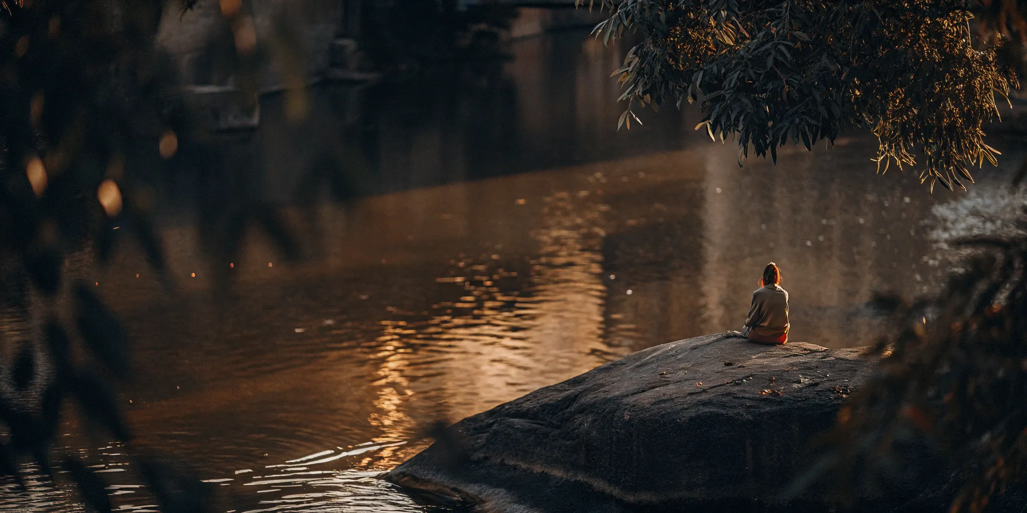 A person meditating by a river for stress and anxiety treatment without medication.