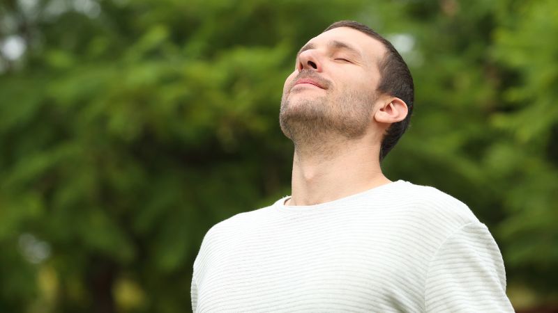 Relaxed adult man breathing fresh air