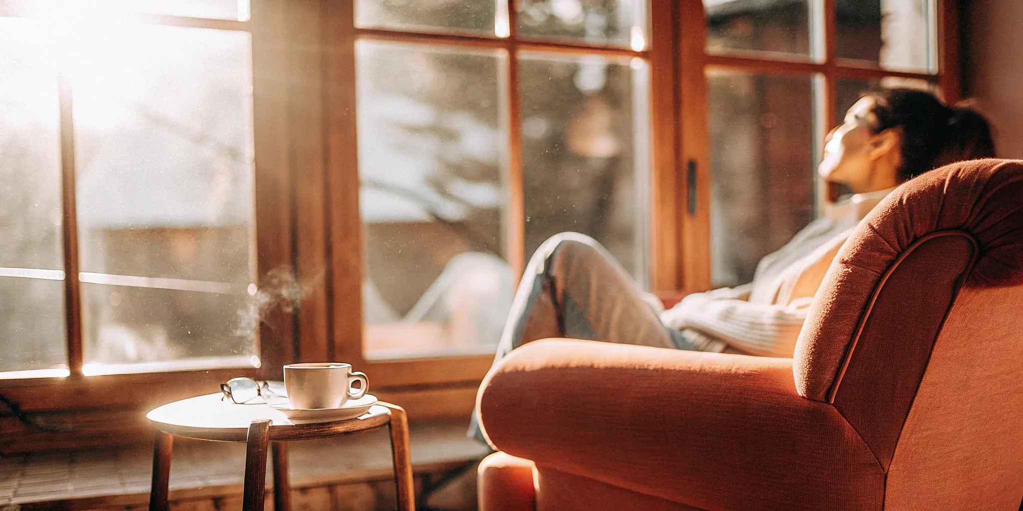 A woman relaxes with coffee while learning how to find a TMS provider for OCD.