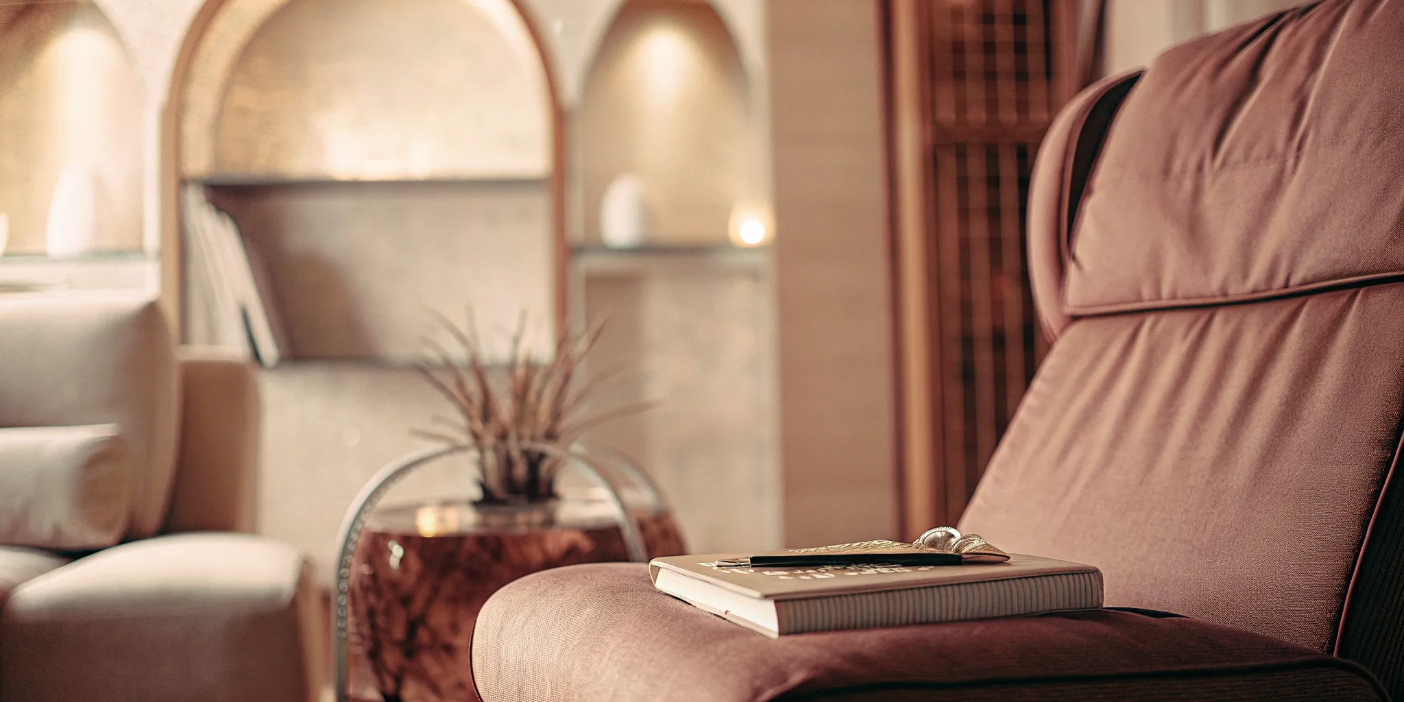 A therapy office chair and notebook, a setting to understand the difference between a psychologist and a therapist.