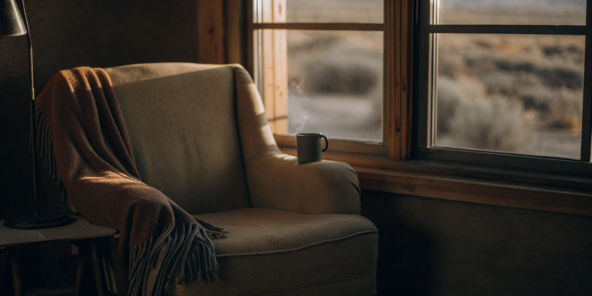 A comfortable armchair by a window for considering the pros and cons of TMS vs ECT.