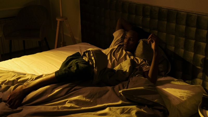 a man lying on bed