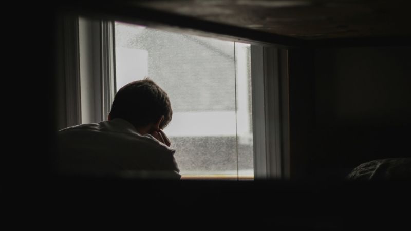 depressed person by the window