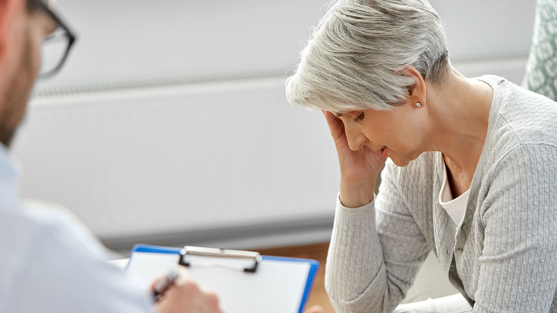 Sad senior woman patient