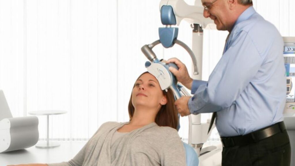 a doctor doing tms therapy on a woman