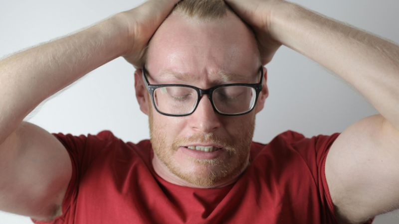 Upset male with headache