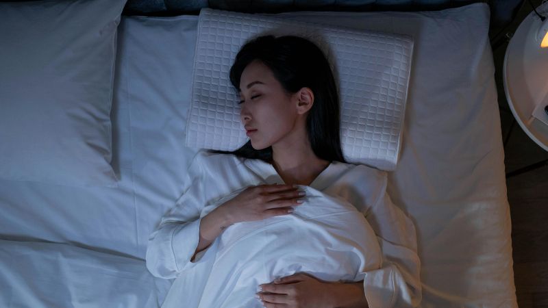 Woman Sleeping on a Bed