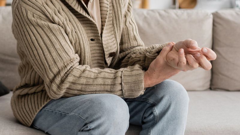 aged man with trembling hands suffering from parkinsonian syndrome