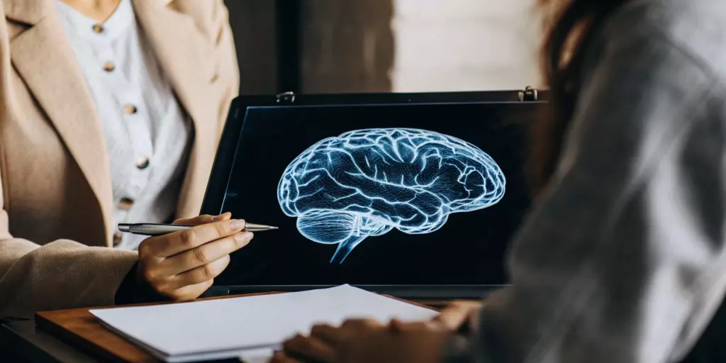 Patient in a TMS consultation views a brain scan to plan the best treatment for major depression.