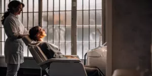 Patient receiving TMS therapy for OCD from a trained professional.