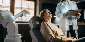 Patient receiving fast TMS depression treatment from a doctor with a modern TMS device.