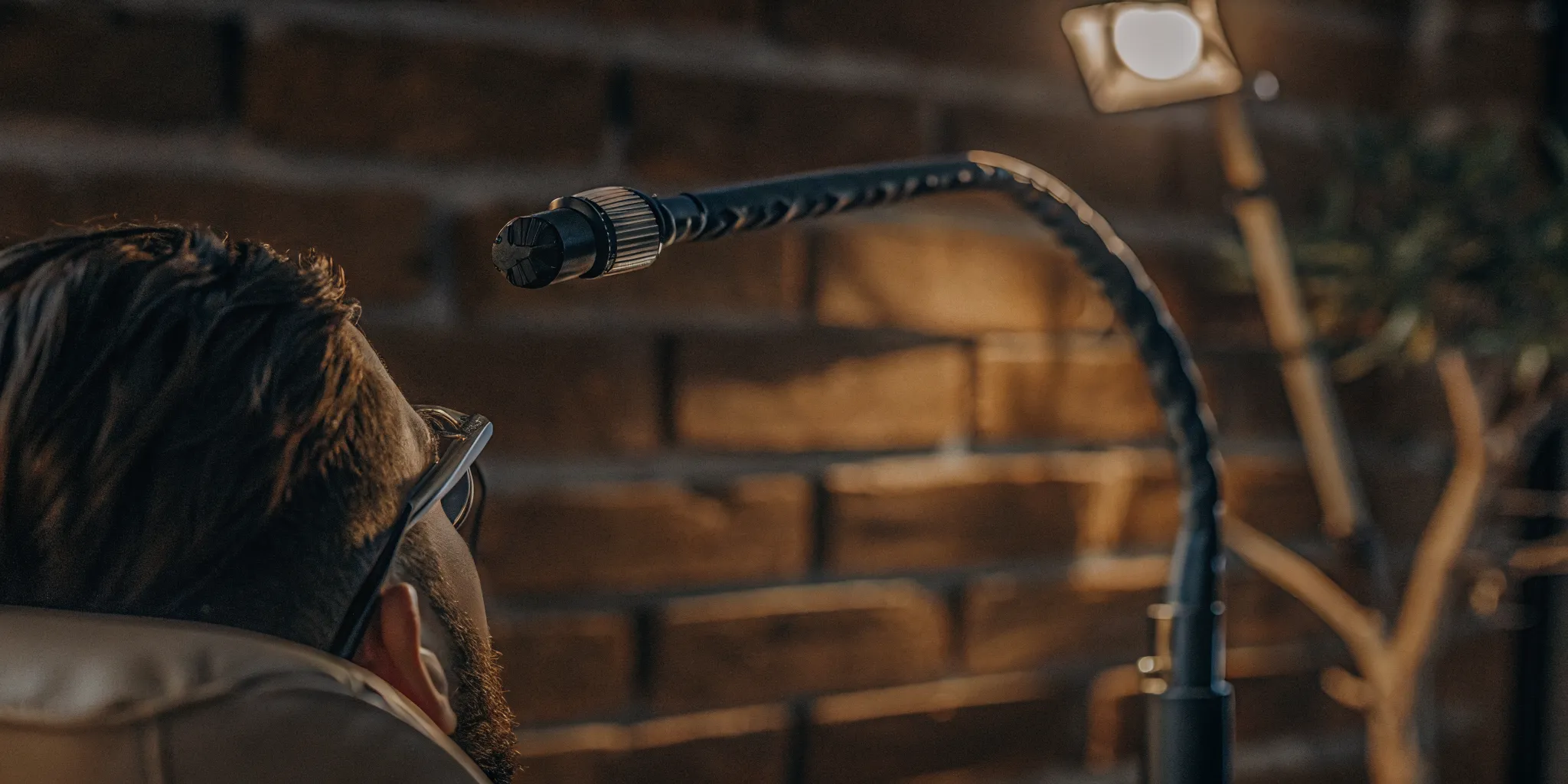 Man receiving transcranial magnetic stimulation therapy as a device sends gentle magnetic pulses to his brain.