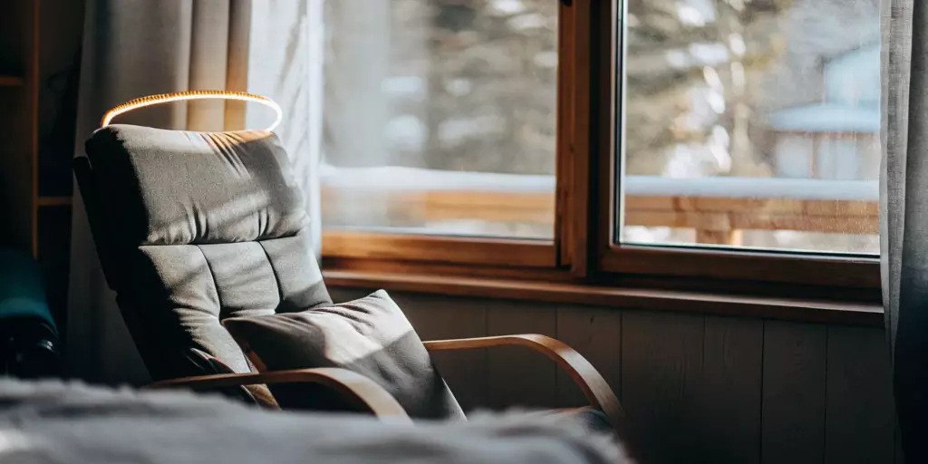 A comfortable armchair in a sunlit room, a safe space to learn the truth about TMS therapy.