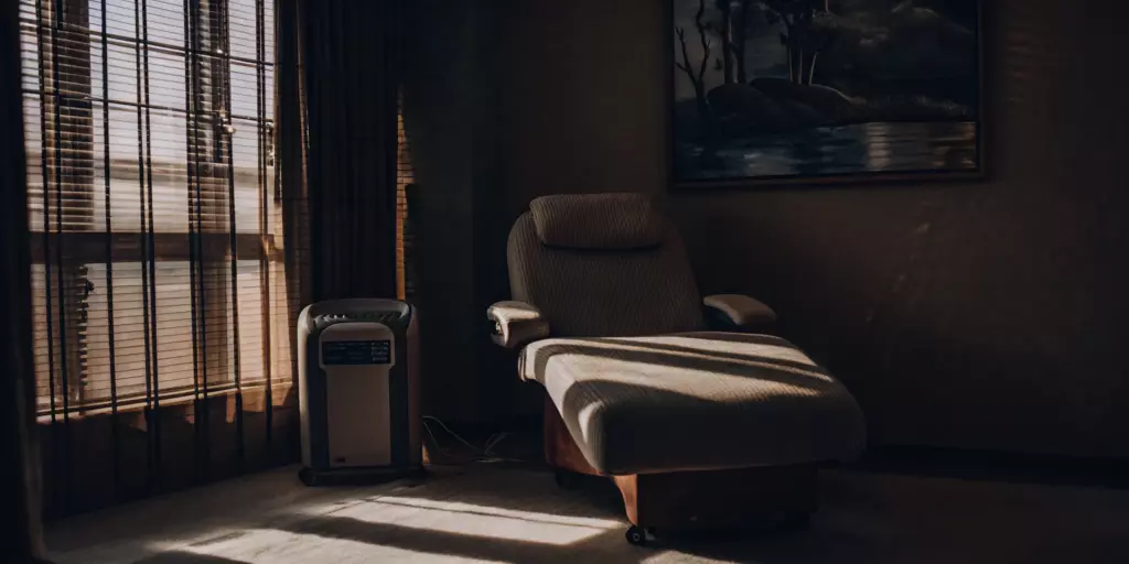 A comfortable chair in a treatment room for a non-invasive TMS procedure.