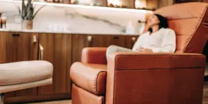 Woman in a comfortable chair receiving Scottsdale TMS therapy for depression.
