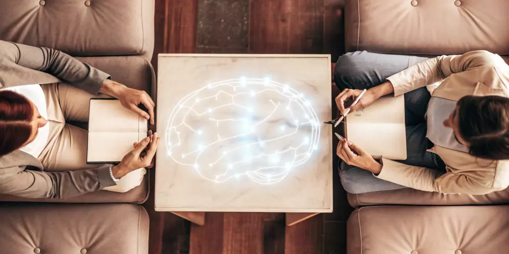 A therapist explains the CBT protocol for OCD treatment using a diagram of the brain.