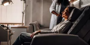 A patient smiles during a relaxing TMS therapy session for OCD.