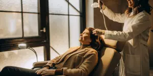 Woman comfortably receiving TMS therapy, a treatment with mild and temporary side effects.