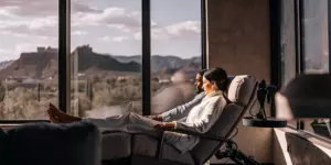 Couple relaxing during TMS treatment for GAD in a Scottsdale clinic with mountain views.