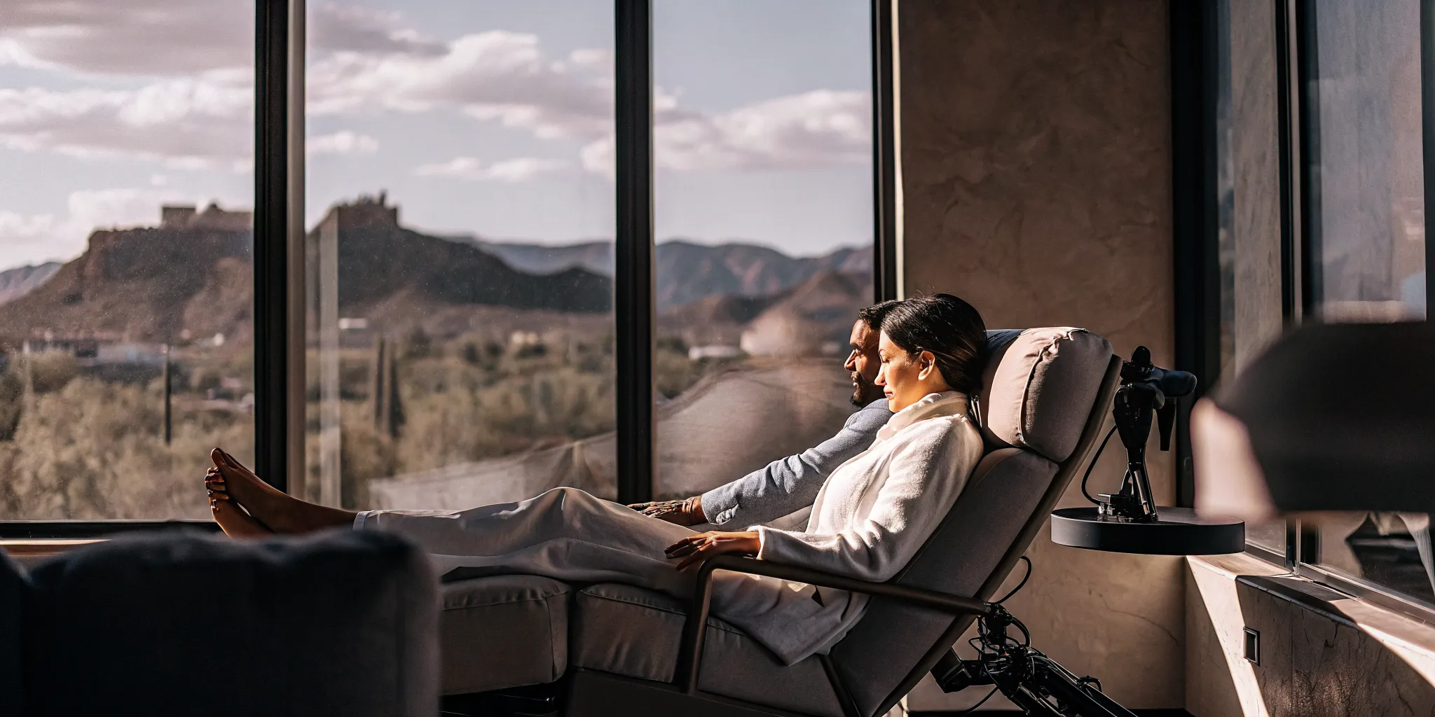 Couple relaxing during TMS treatment for GAD in a Scottsdale clinic with mountain views.