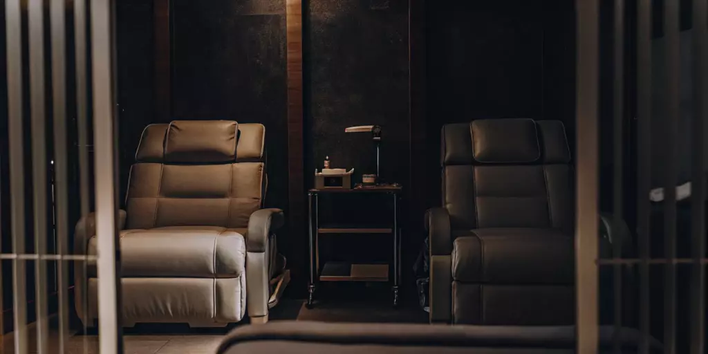 A clinical treatment room with chairs used to compare the effectiveness of TMS vs ECT for depression.