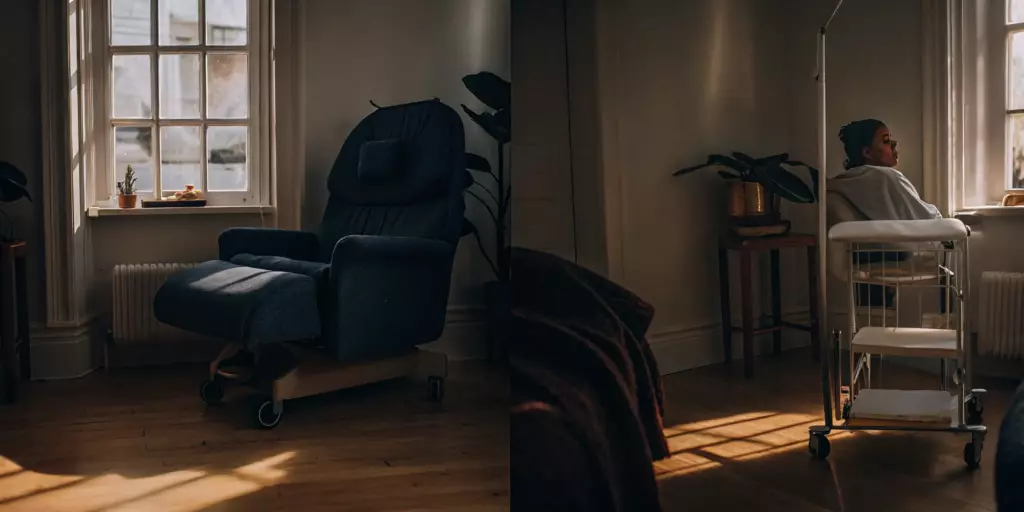A patient in a chair next to a TMS device, a modern brain therapy compared to ECT.
