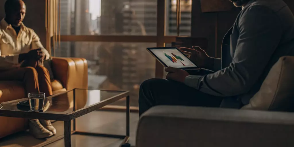 A psychiatrist and patient review a treatment plan for resistant depression on a tablet.