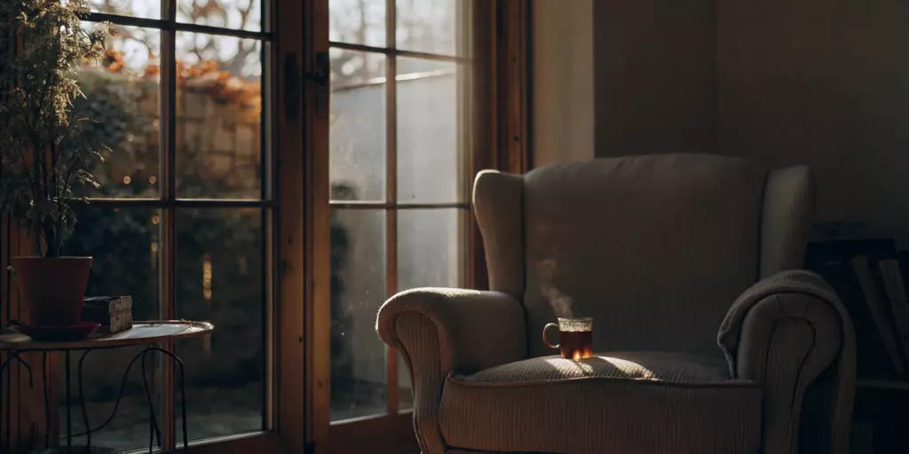 A comfortable armchair in a sunlit room, a calm space to find the best alternative to antidepressants.