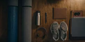 Yoga mat, sneakers, and a journal as tools for non-medication depression treatment.